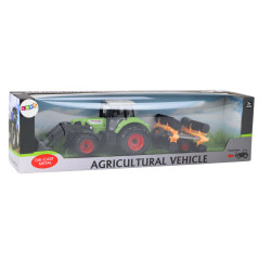 Jordbruks traktor med skopa och skivharv, grön drivning.