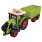 Lyckliga människor med en Claas-traktor med släpvagn.